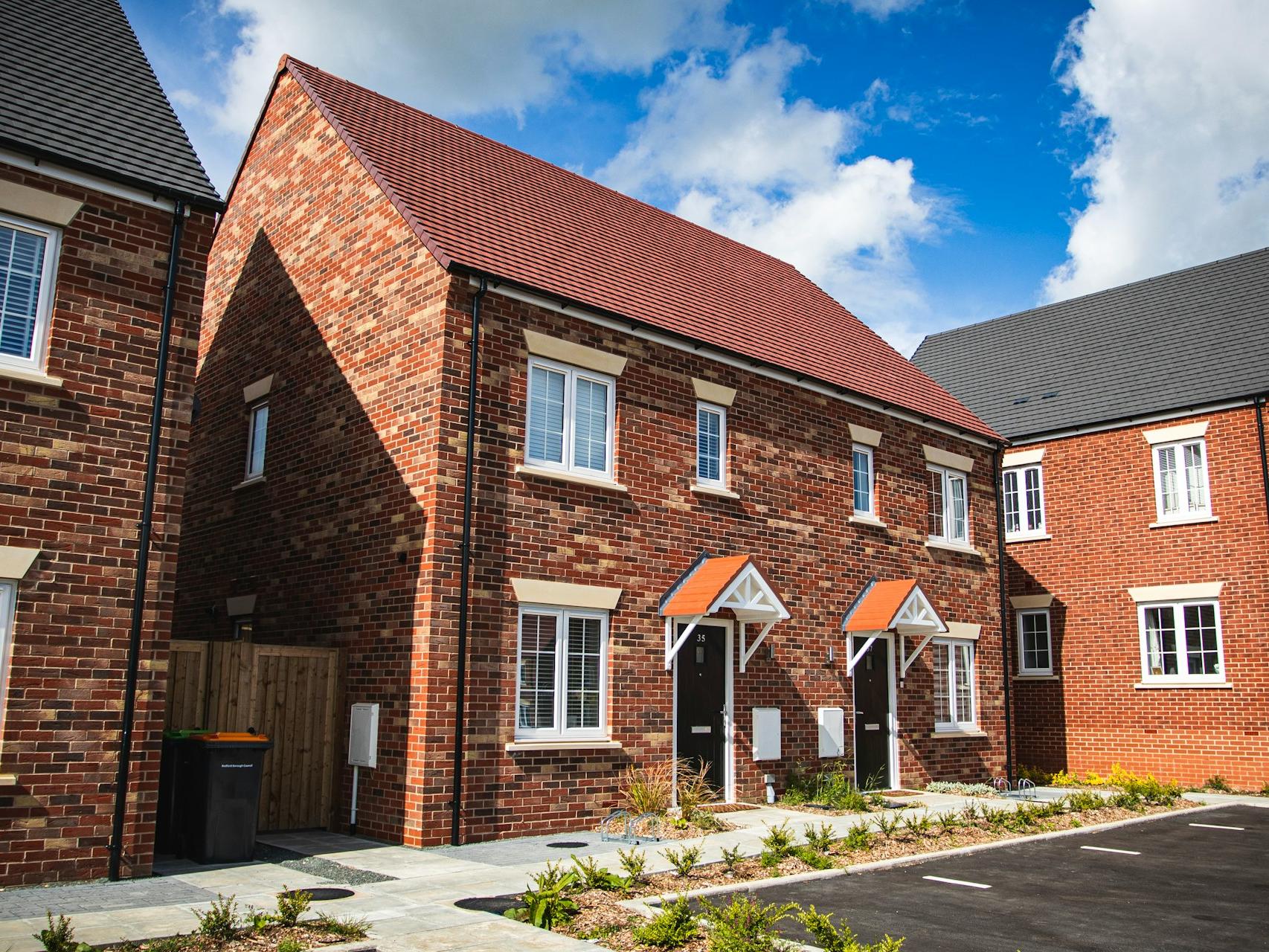 brown brick house under blue sky during daytime
